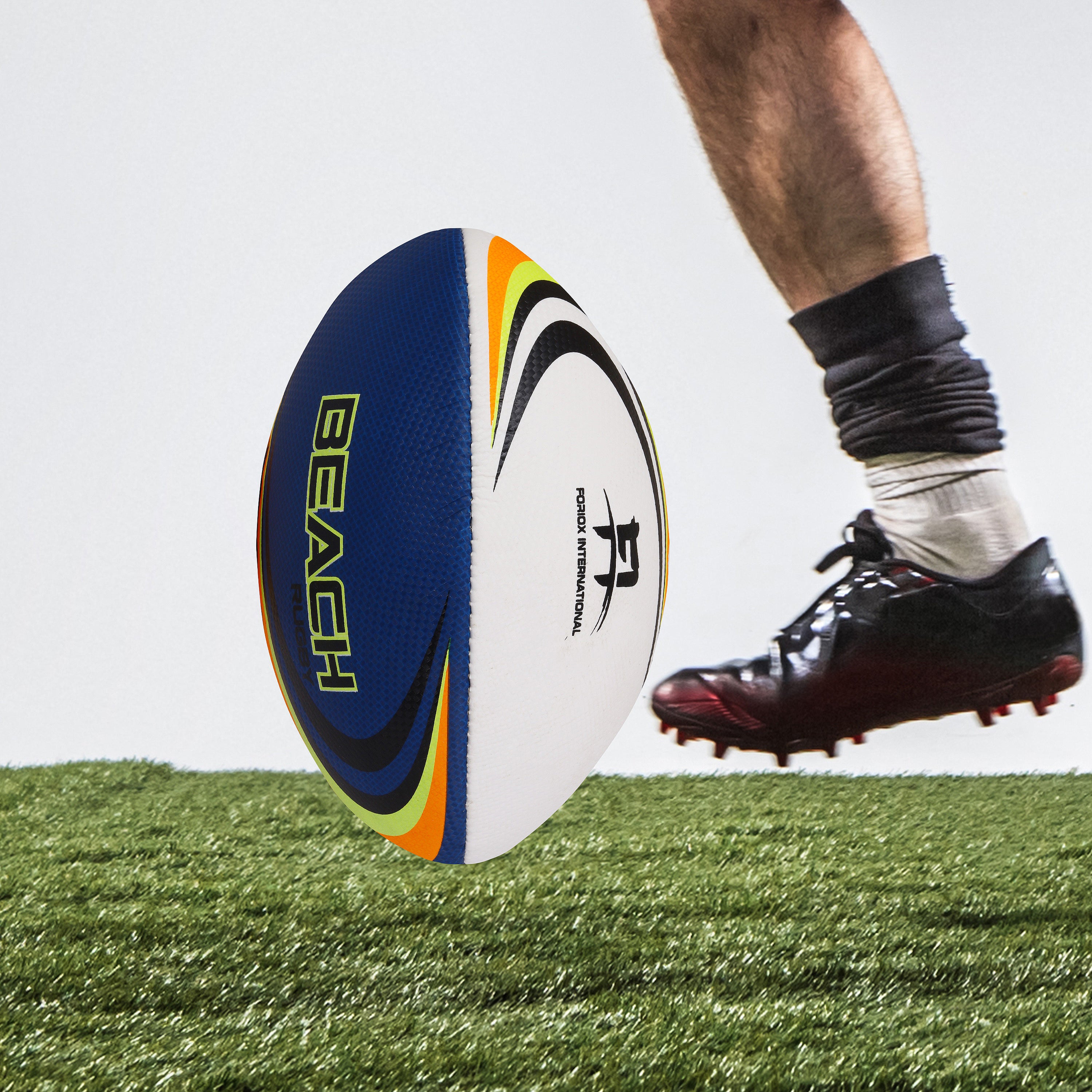  Oval-shaped rugby ball on grass field, ready for a match.